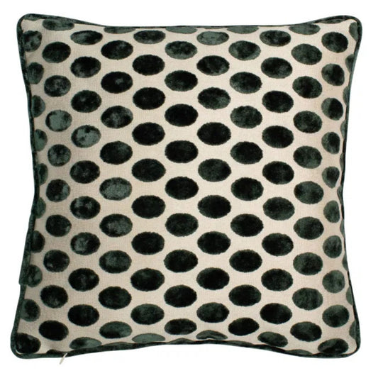 A square-shaped cushion with a deep green velvet polka dot pattern on a natural beige background, accented with green piping.