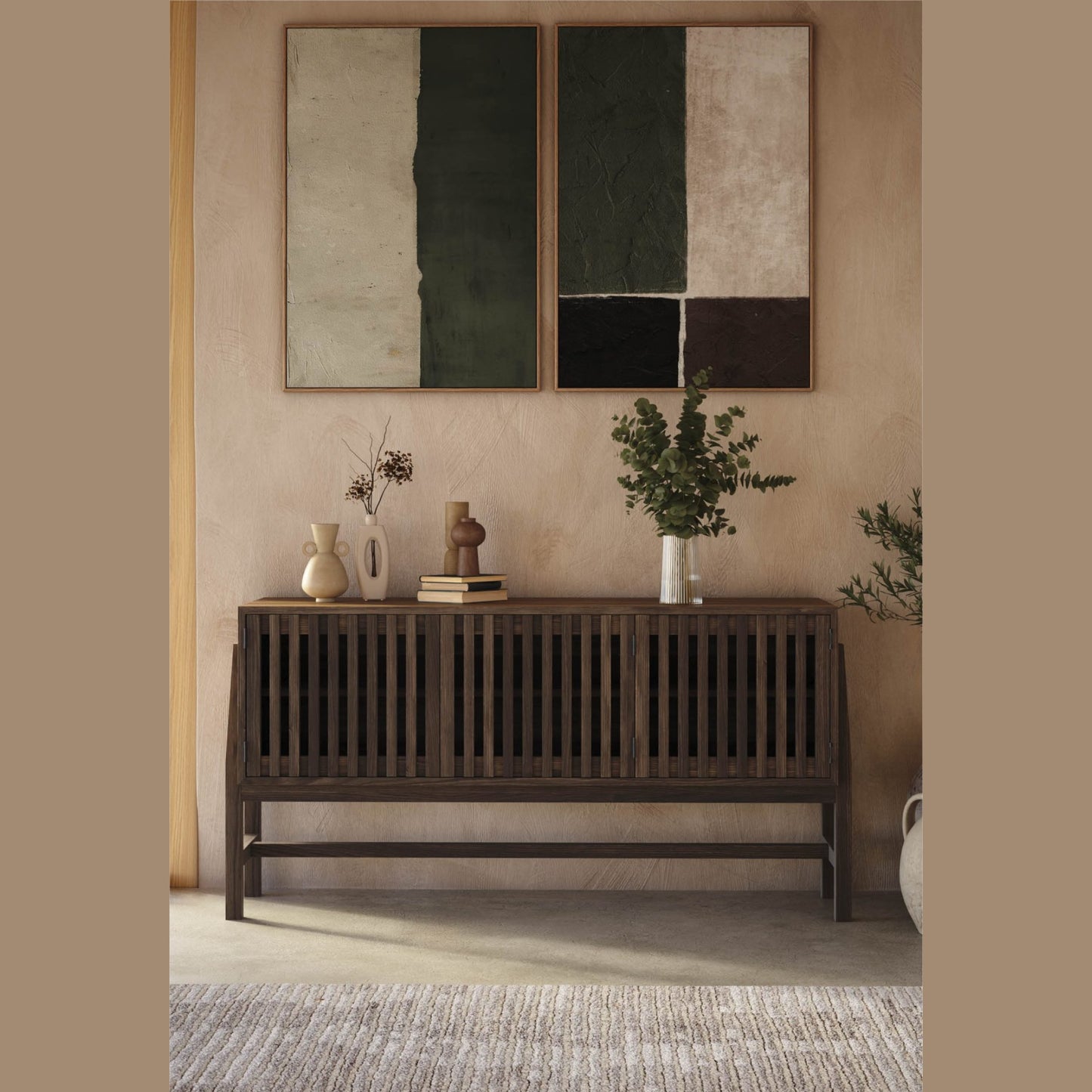 Wooden console table with decorative items against a beige wall with abstract art