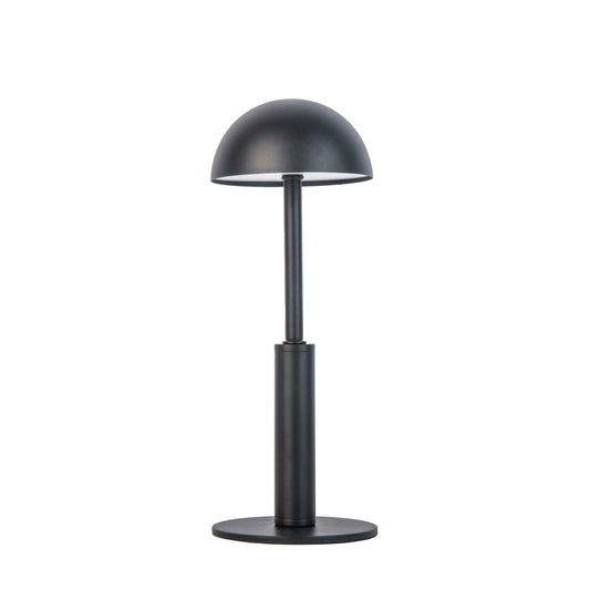 Black dome shaped metal table lamp on a white background