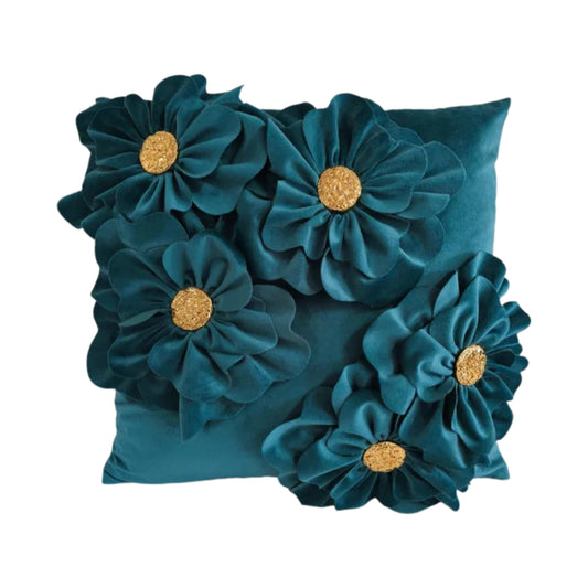 Teal pillow with floral decorations on a white background