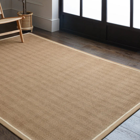 Beige rug on a wooden floor with a chair and plant in the background