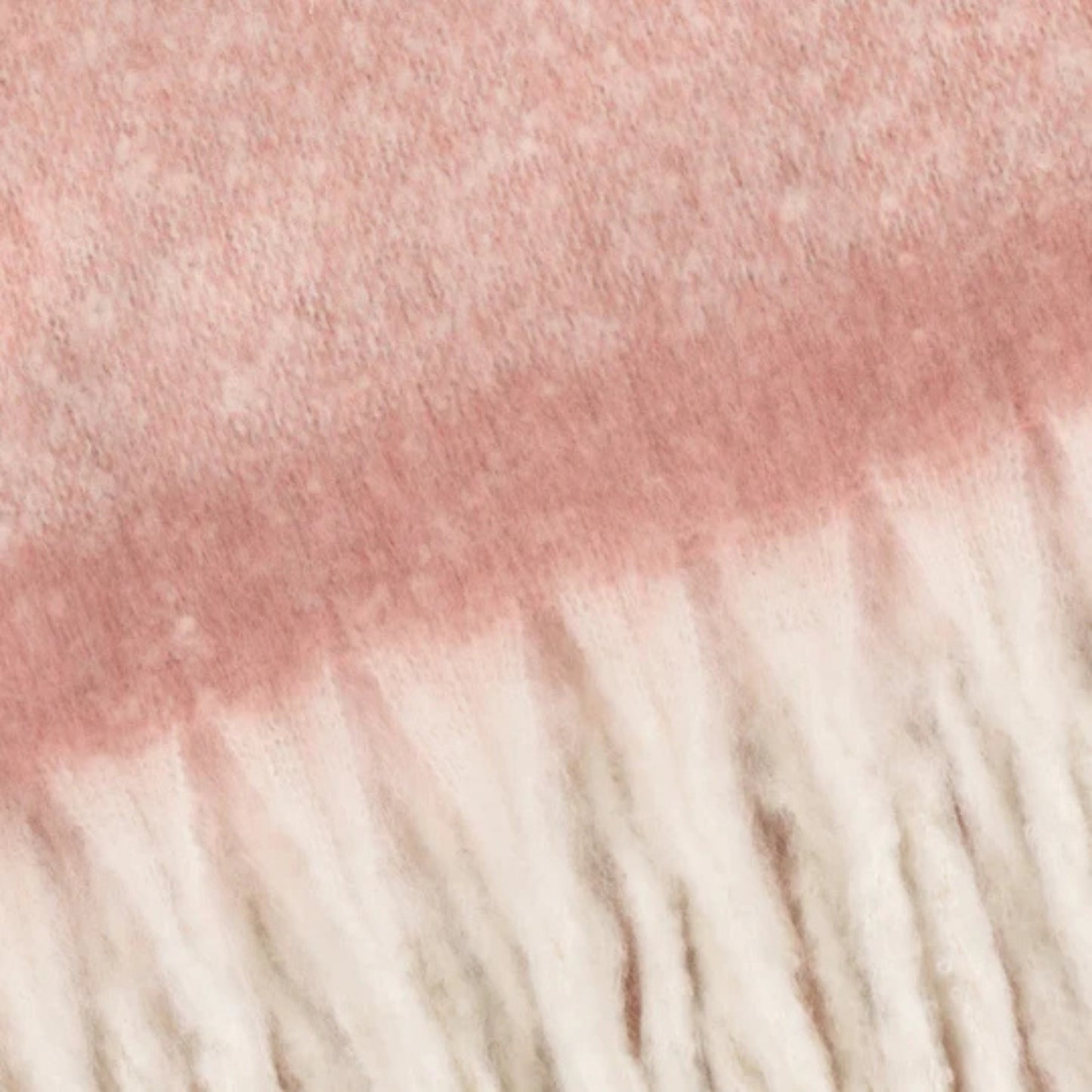 Close-up of pink and white yarn with fringes