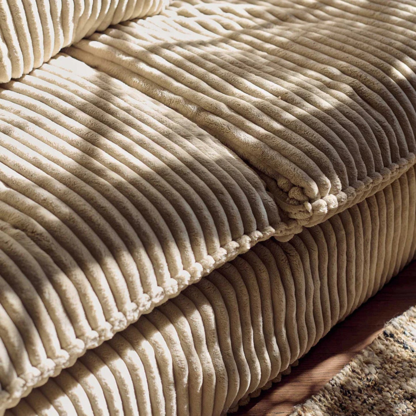Close-up of a beige corduroy fabric surface
