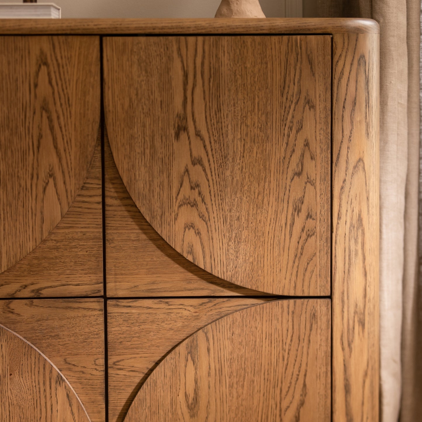 Close-up of a wooden cabinet with a focus on the wood grain and texture.
