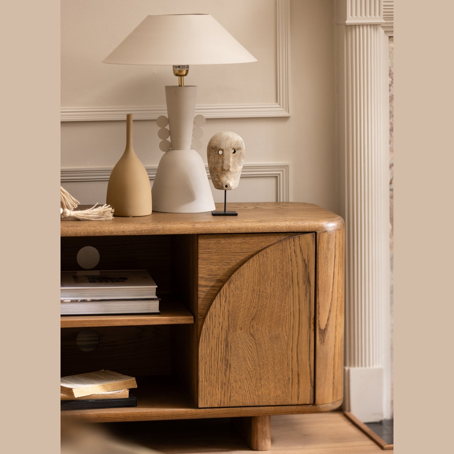 Oak tv unit with shelves and doors with decorative items in a room setting