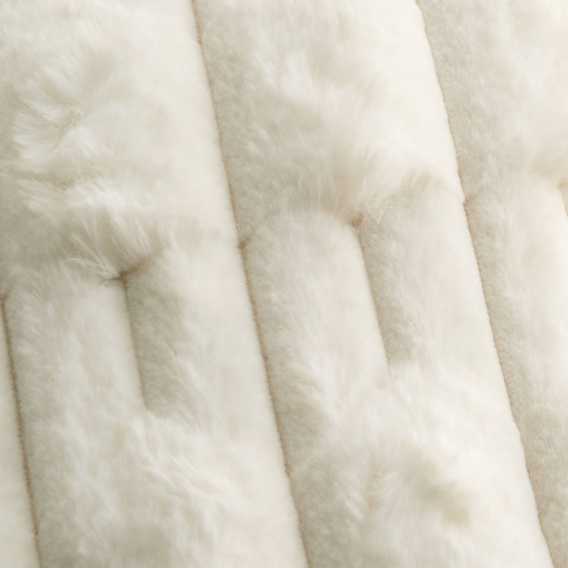 detailed close up of faux fur cream cushion