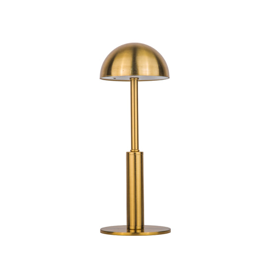 Gold dome shaped metal table lamp on a white background