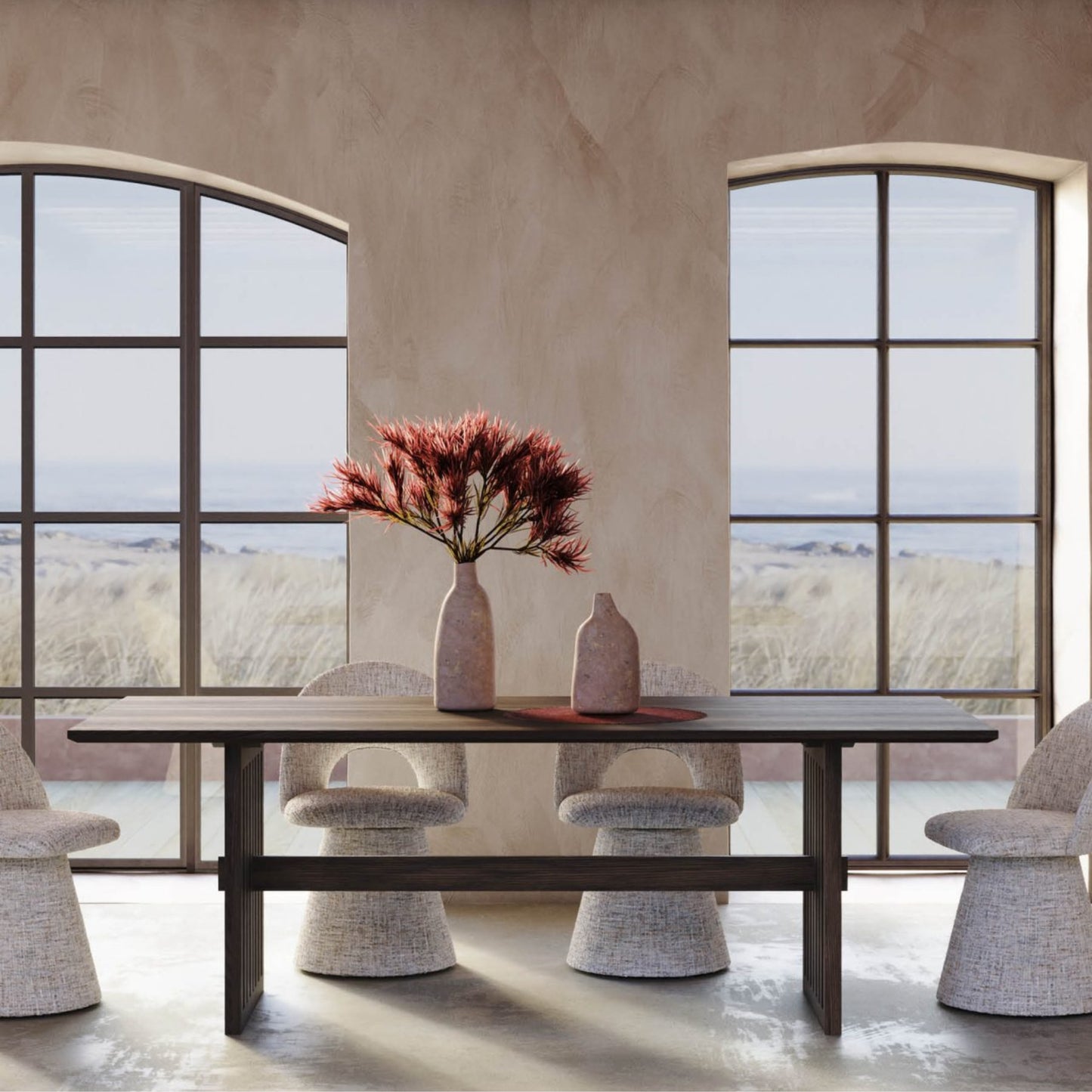 Dining table with chairs and a vase of flowers in a room with large windows.