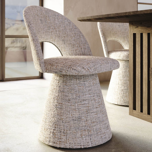 Textured chair in a modern interior setting with a wooden table and abstract art.