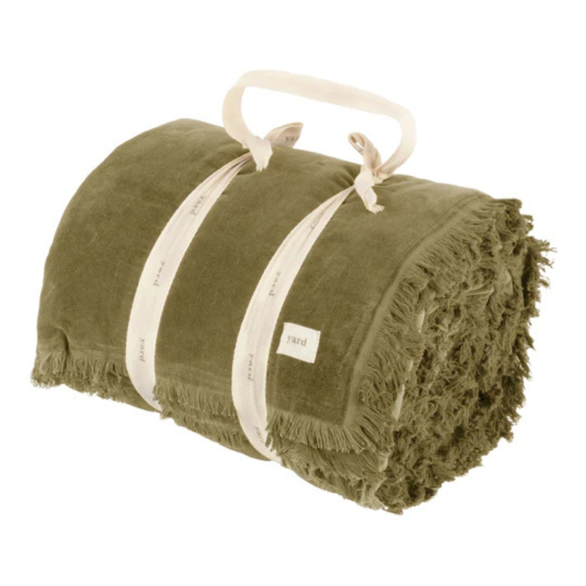 Rolled up green bedspread tied with white cotton ribbon on a white background