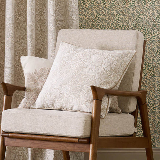 Chair with patterned cushions against a decorative wall.