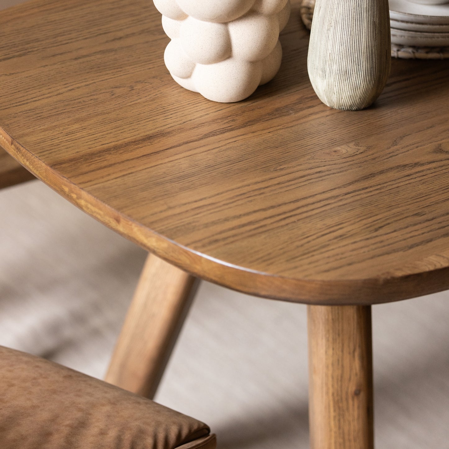 Wooden side table with decorative items on a neutral background
