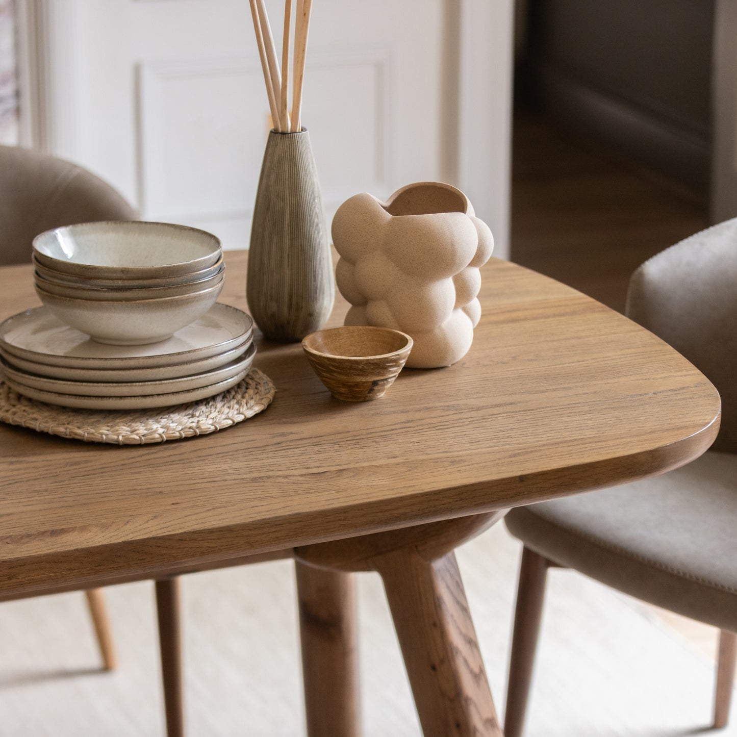 Oak dining table with decorative ceramics on top