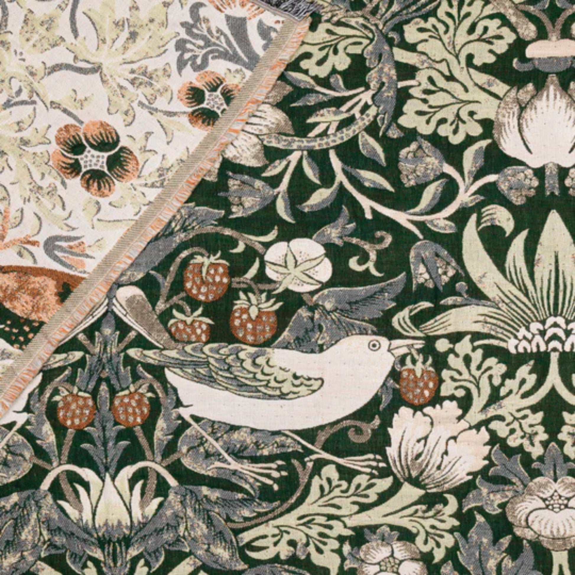 Decorative fabric pattern with birds, flowers, and leaves on a green background