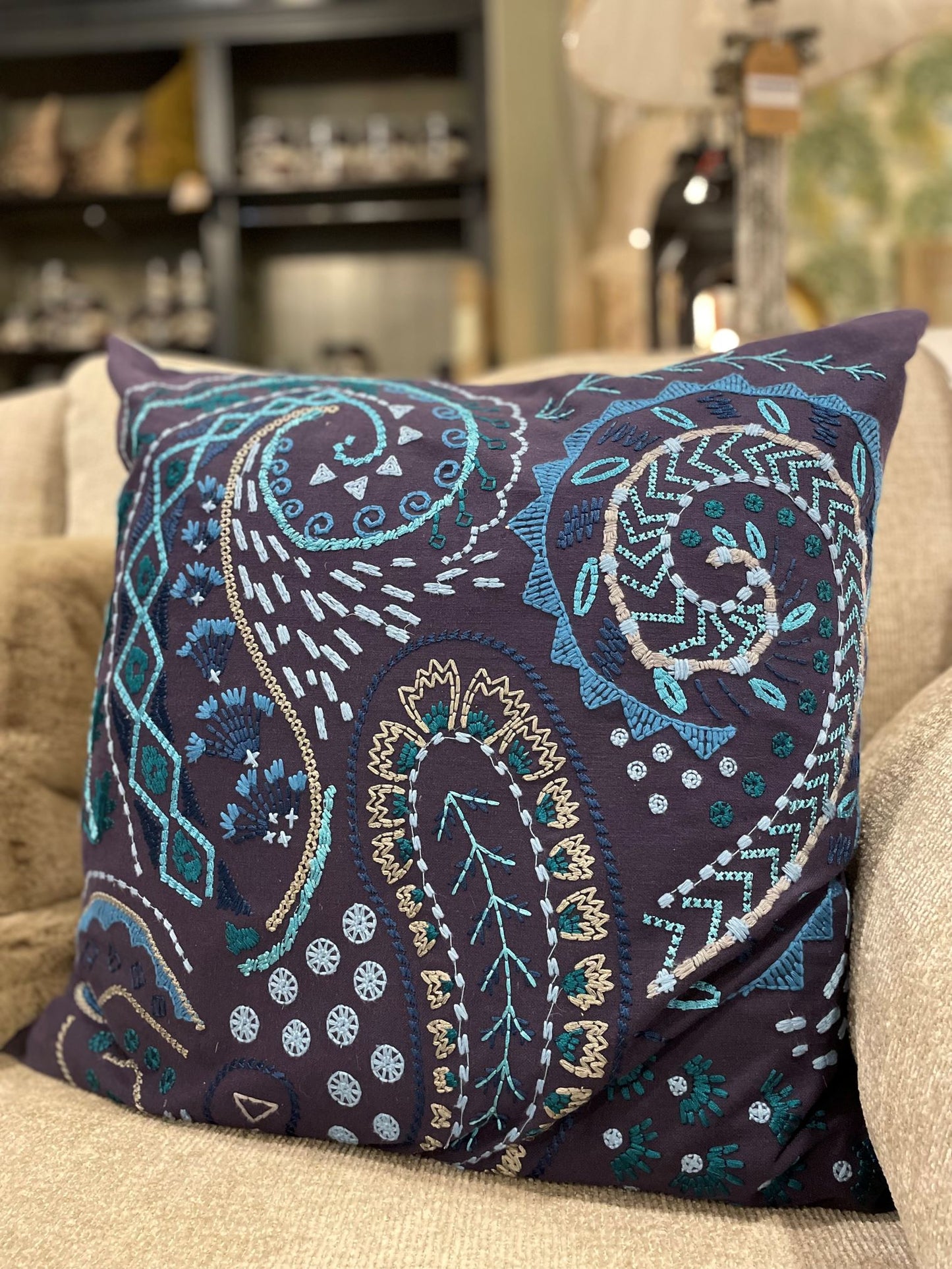 Embroidered blue tones on navy background large cushion