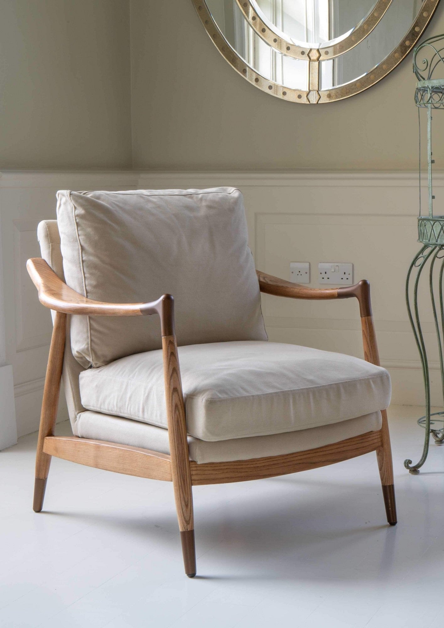 An elegant Archie Accent Chair with a solid ash timber construction and an upholstered ivory canvas seat and back cushion.