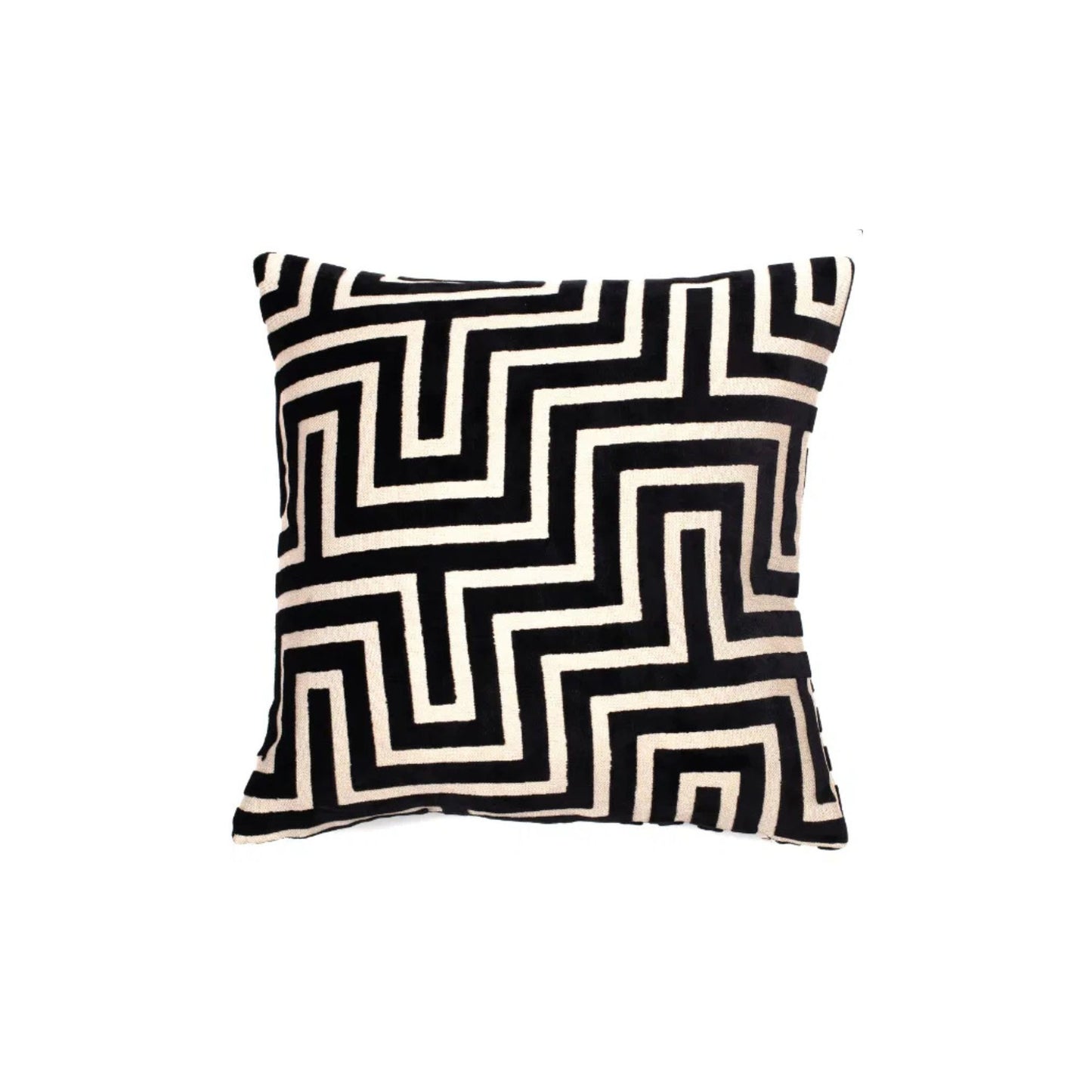 A black and white geometric patterned velvet cushion.