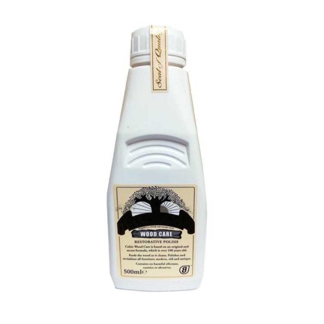 A bottle of Celtic Wood Care Furniture Polish with a white label and a black and gold design detail.