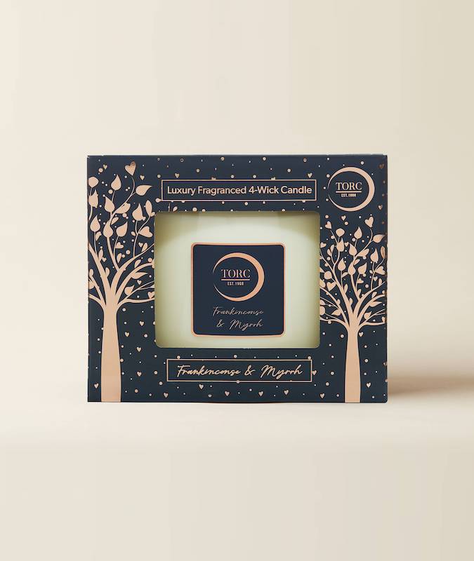 Large torc white candle in a navy gift box on a white background