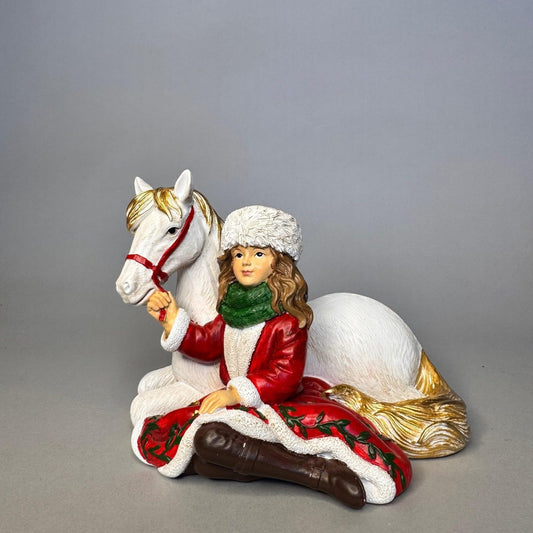 Girl in Santa suit with white pony