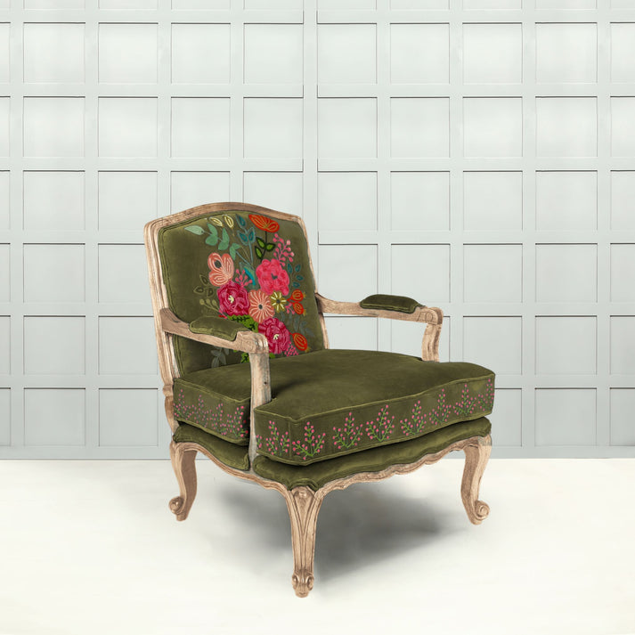 Indulge in the luxury of this timeless carved chair. Finished in a soft grass green velvet, rich with vibrant embroidered floral design, it adds a unique and stunning touch to any space.undefined