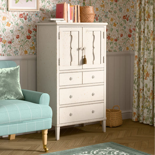 White dresser with decorative items against a floral wallpapered wall.
