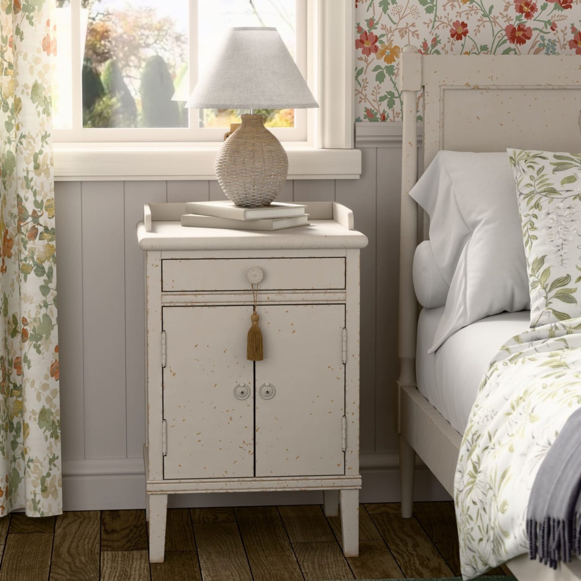 Bedroom with a nightstand and bed featuring floral curtains and wallpaper.