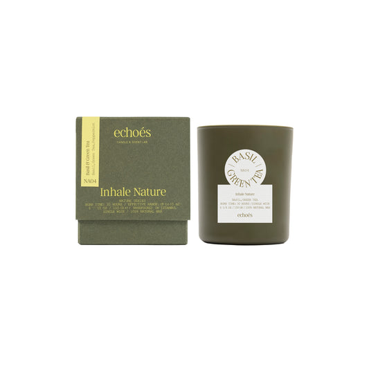 A green tumbler candle with a label reading 'Basil Green Tea', alongside its packaging box which has 'Inhale Nature' written on it.