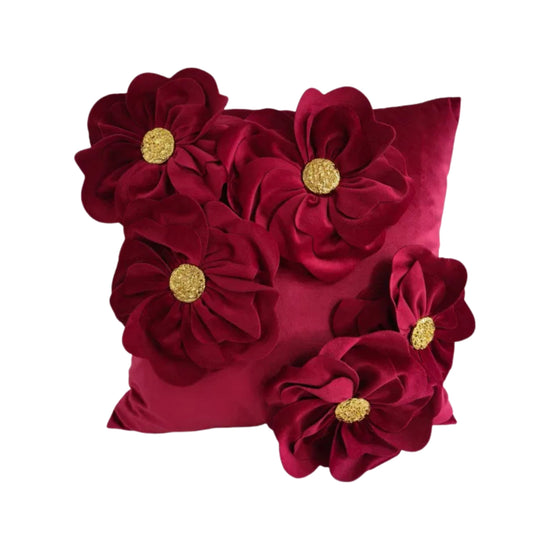 Fuschia decorative pillow with floral embellishments on a white background