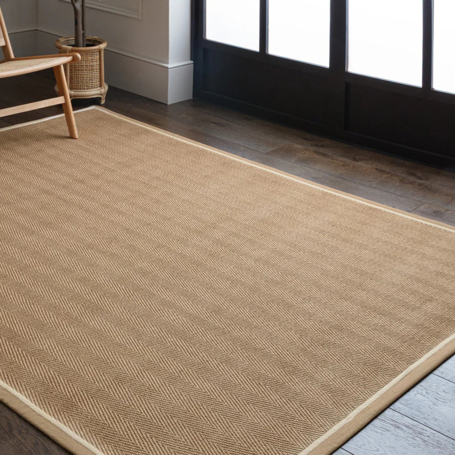 Beige rug on a wooden floor with a chair and plant in the background