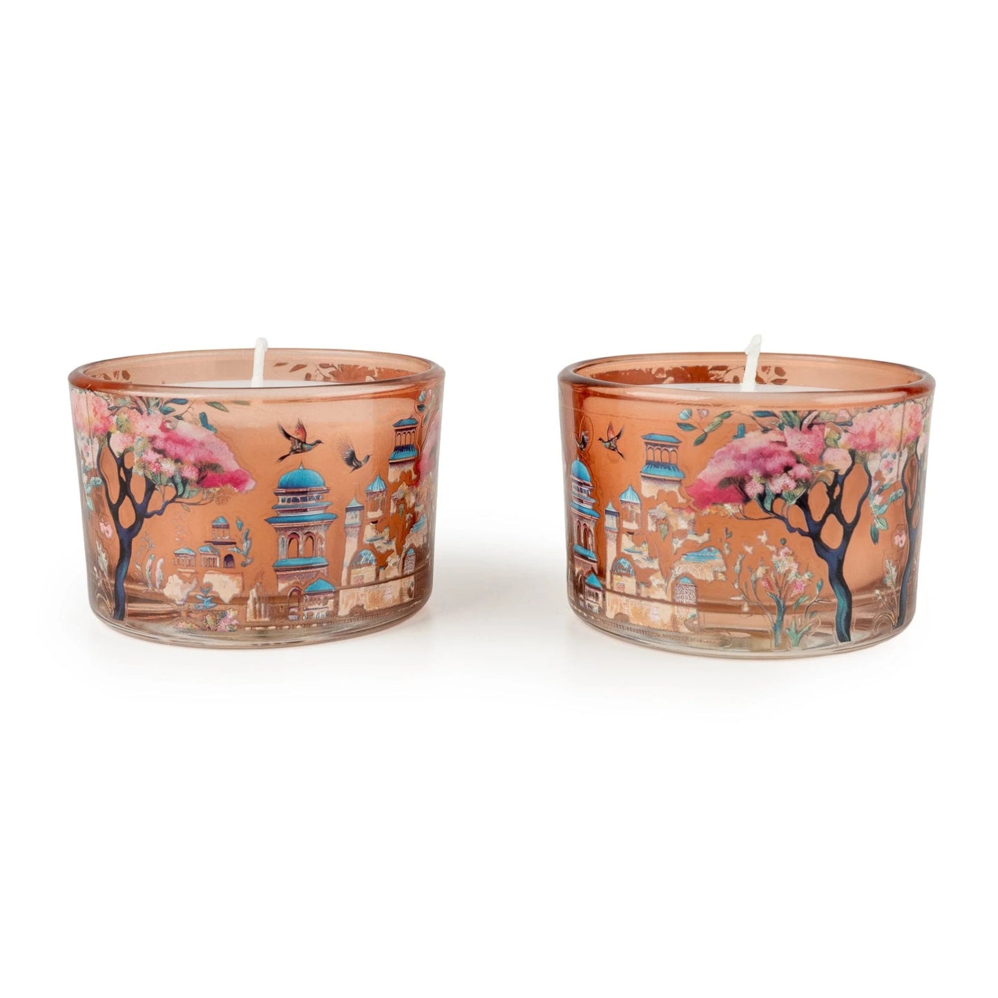 Two decorative candles with artistic designs on a white background