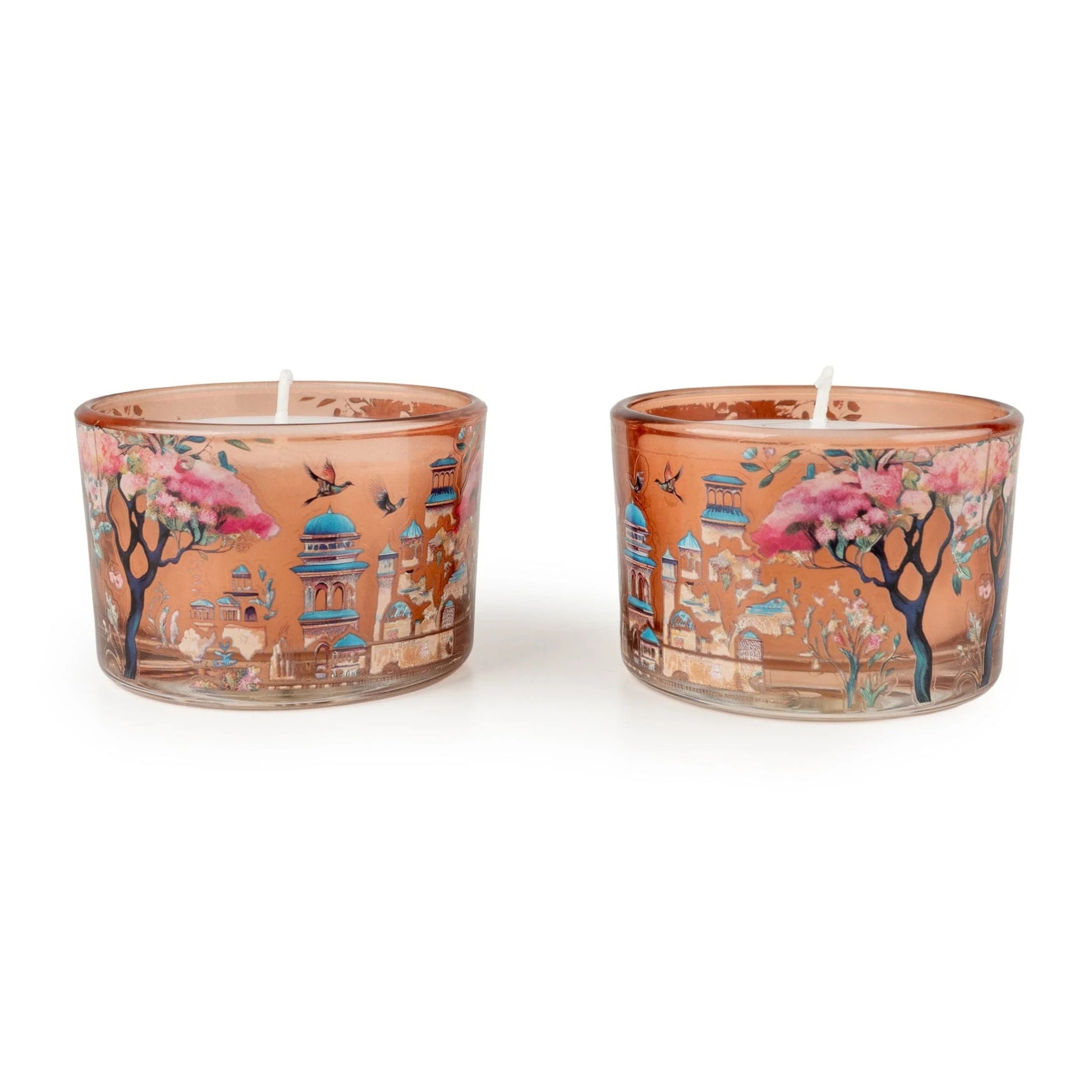 Two decorative candles with artistic designs on a white background