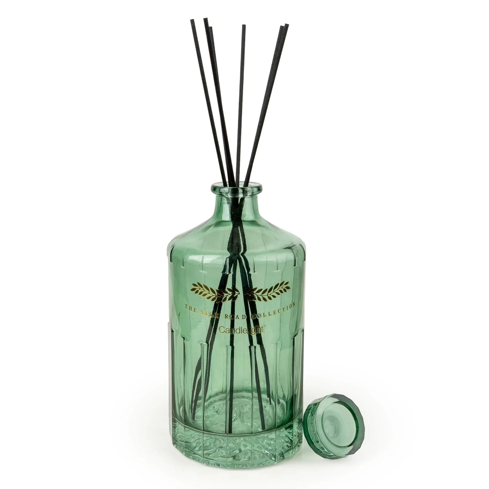 Green diffuser bottle with black sticks on a white background