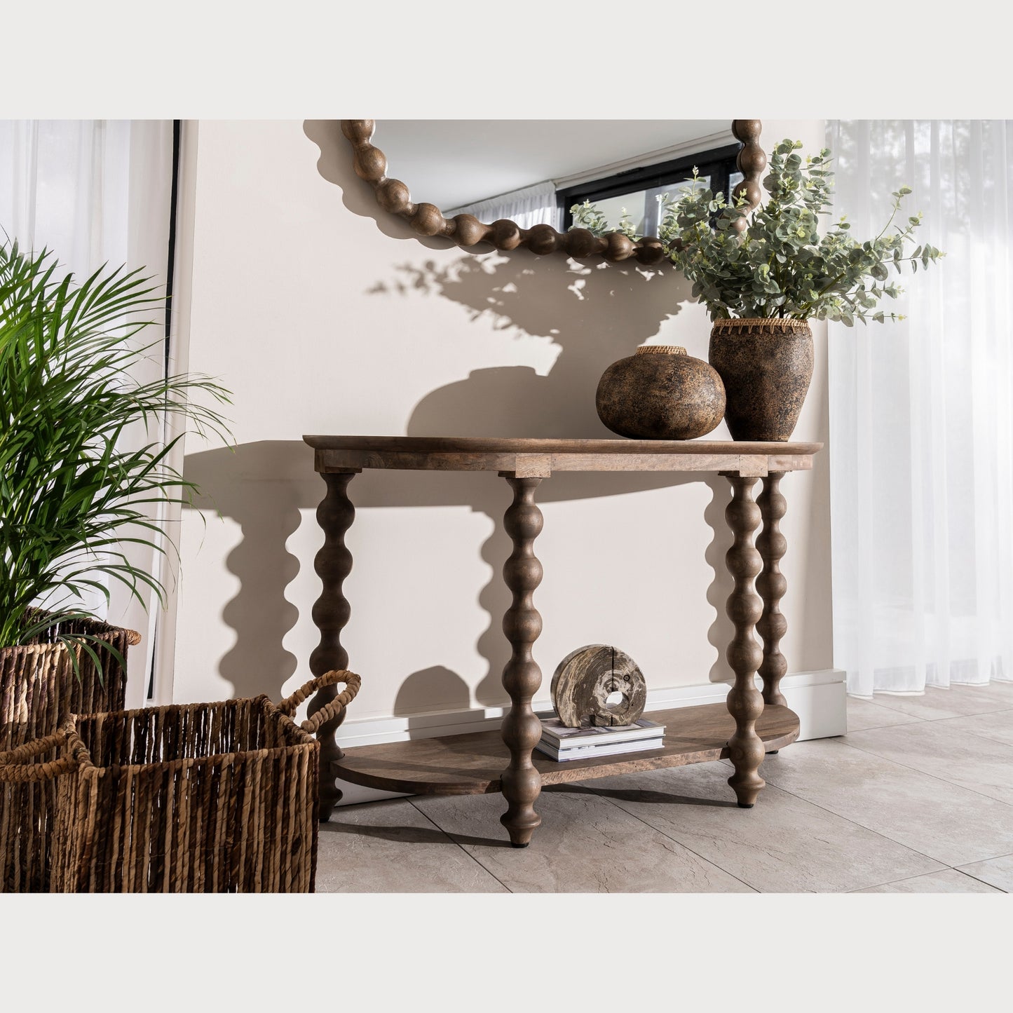 Wooden console table with decorative items in a room setting