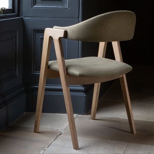 Fabric green chair with wood arm and leg details 