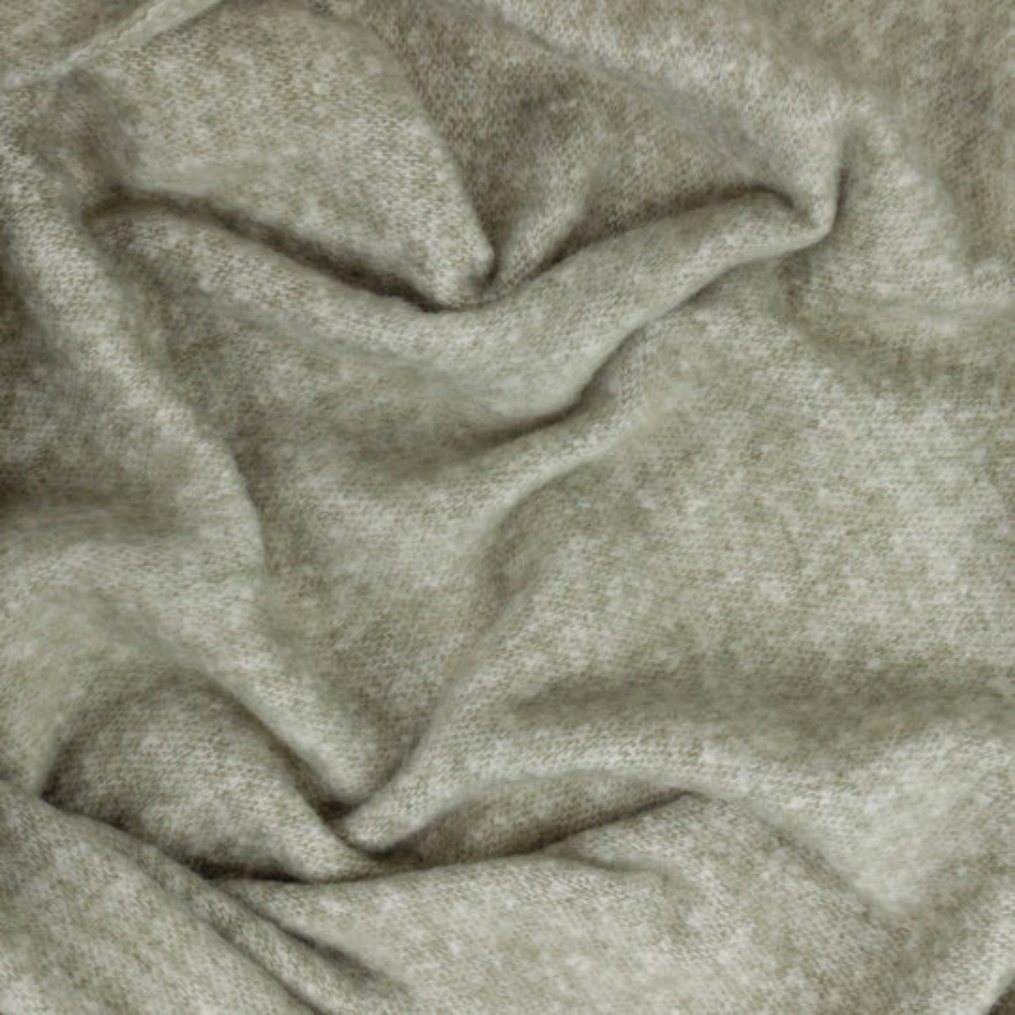 Close-up of textured green fabric with folds