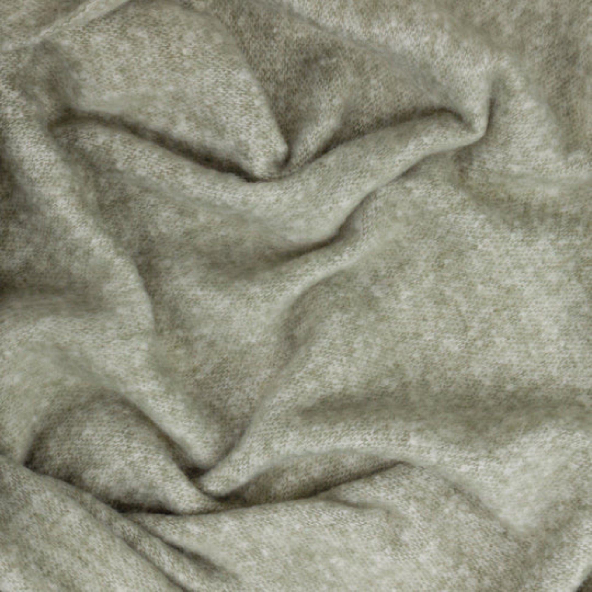 Close-up of textured green fabric with folds