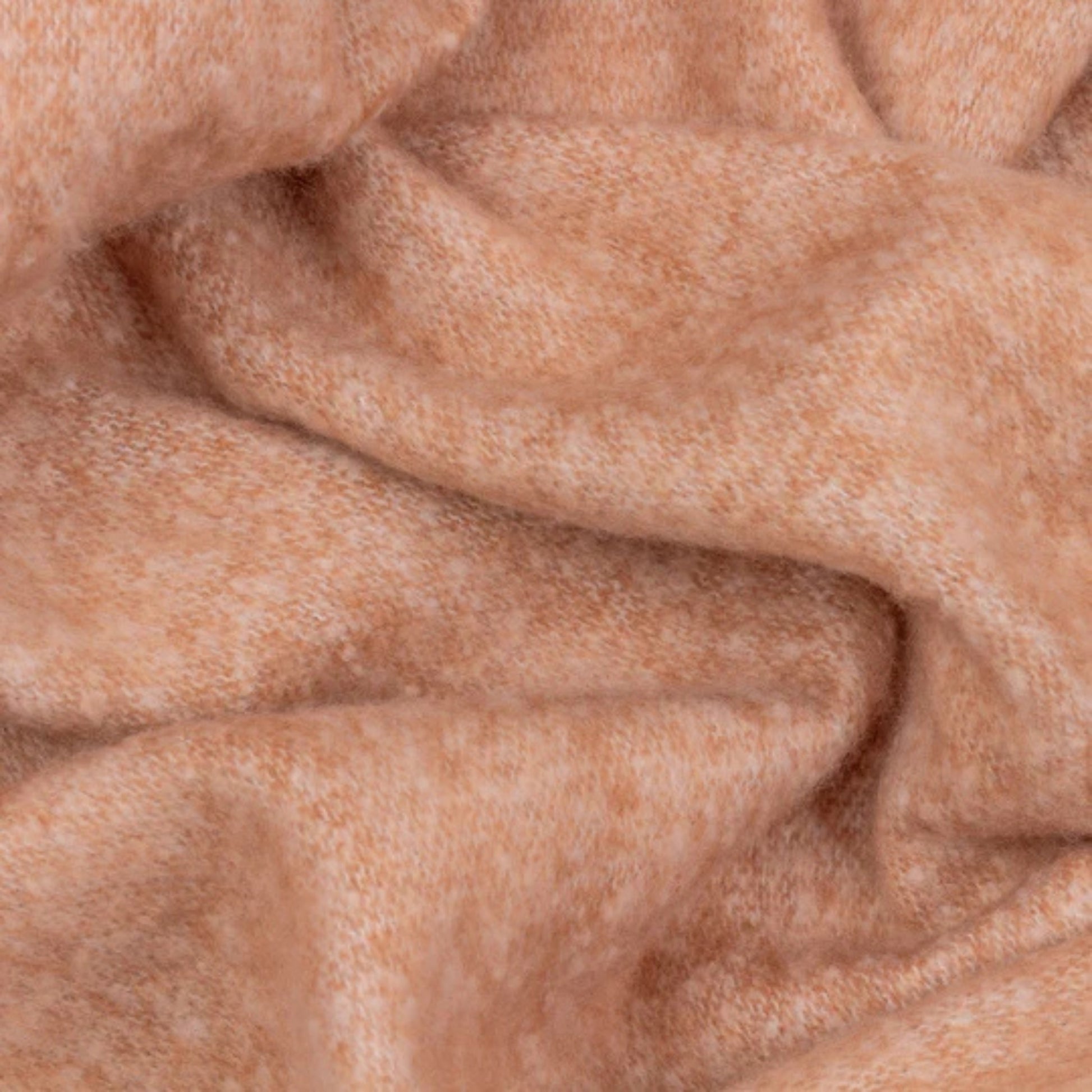 Close-up of soft toned rust fabric with visible texture