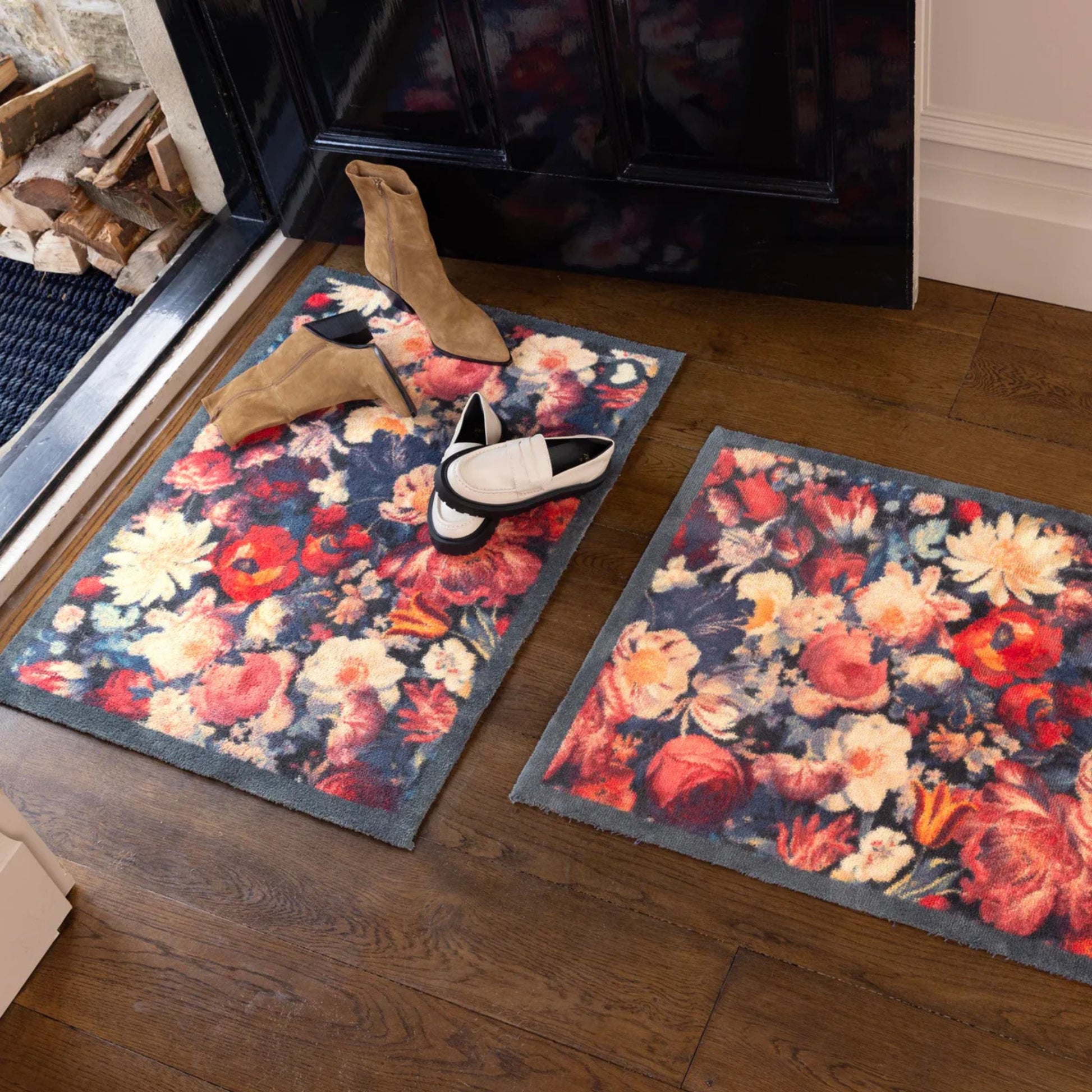 Floral patterned rug on a wooden floor with shoes and a fireplace in the background.