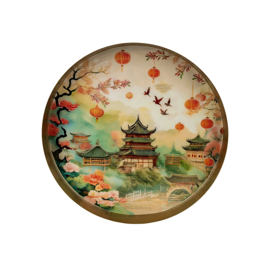 Decorative tray with a scenic design of a traditional building, trees, and lanterns on a white background.