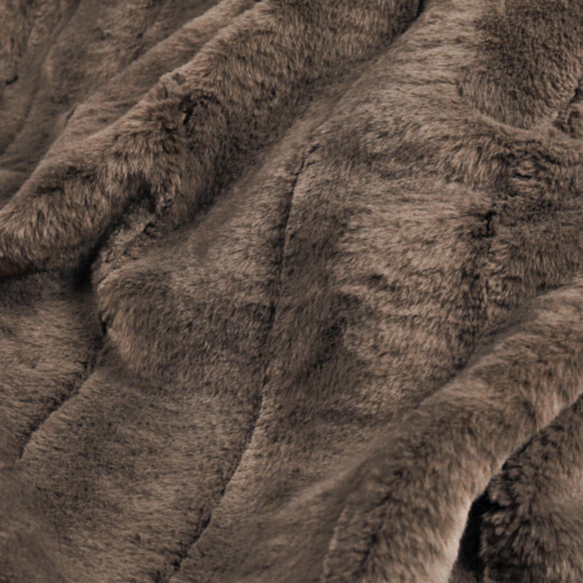 Soft brown faux fur fabric of a throw 