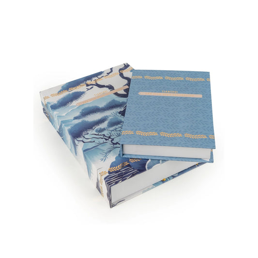 Blue book with floral design on a white background