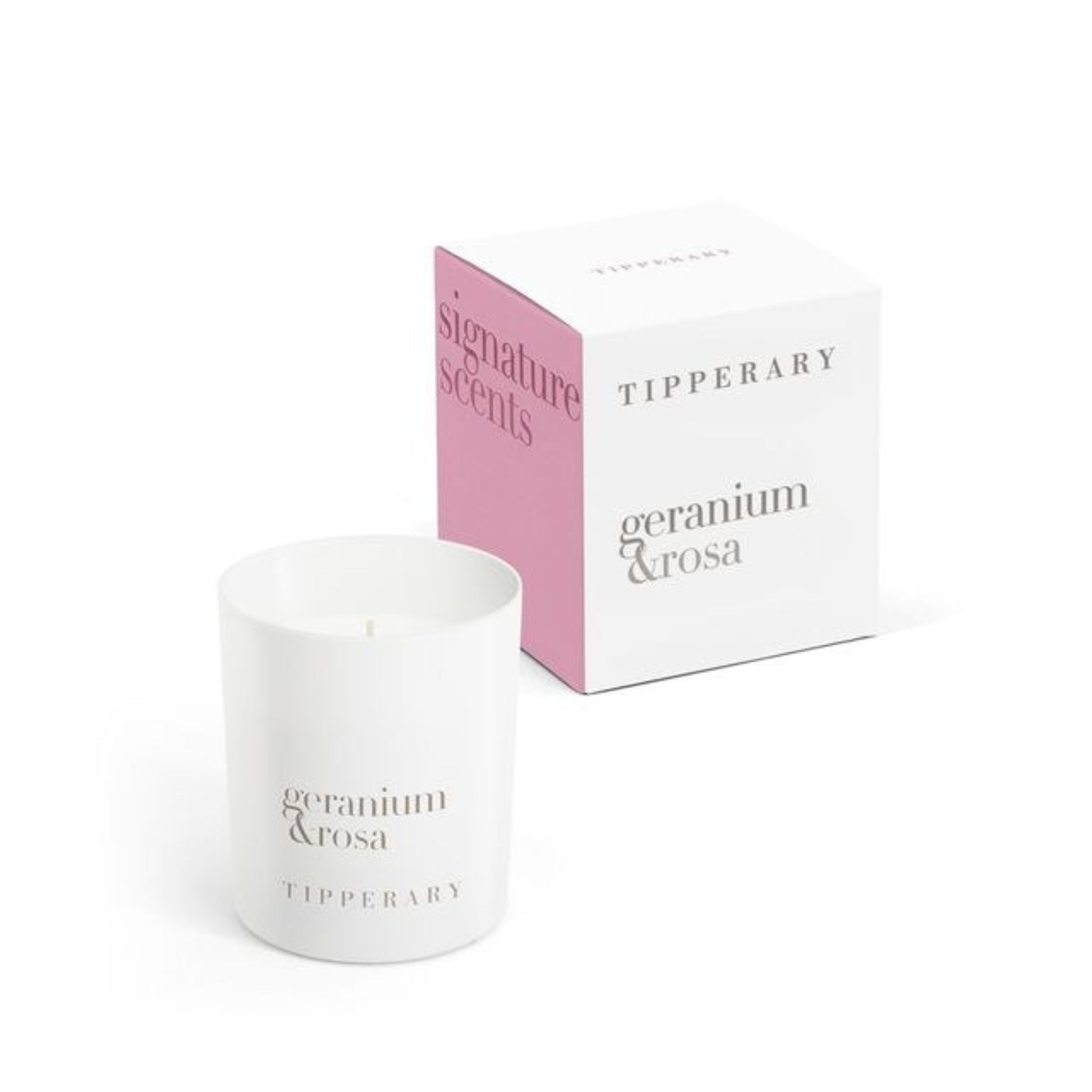 White candle with 'Tipperary geranium & rosa' branding next to a pink and white box on a white background