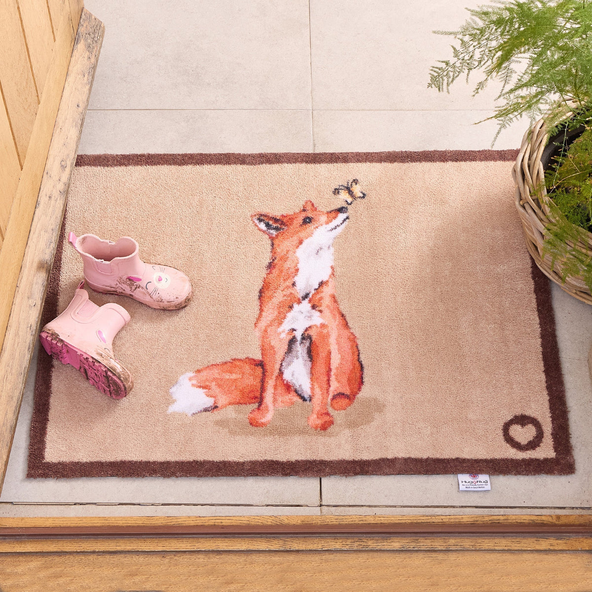Ginger Fox Hug Rug mat in a doorway