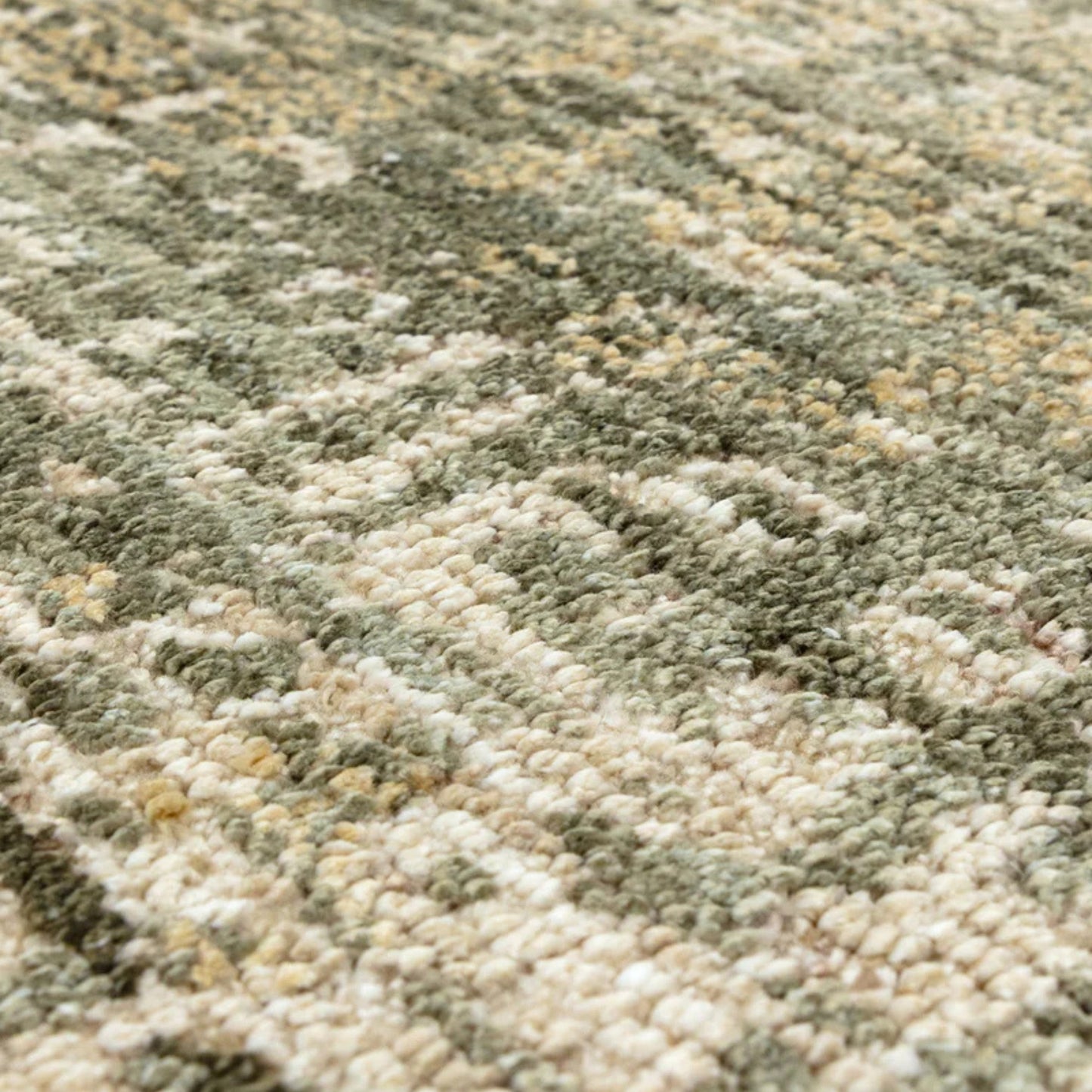 Close-up of a textured green and beige carpet