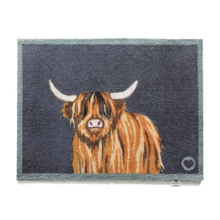 Hug rug washable doormat with a charcoal grey background and a highland cow design in the centre. 