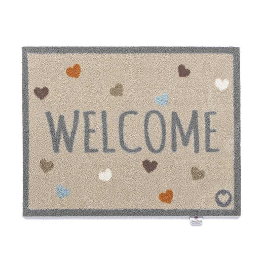 Hug Rug washable door mat with a beige background and Welcome print with small hearts pattern in soft colours