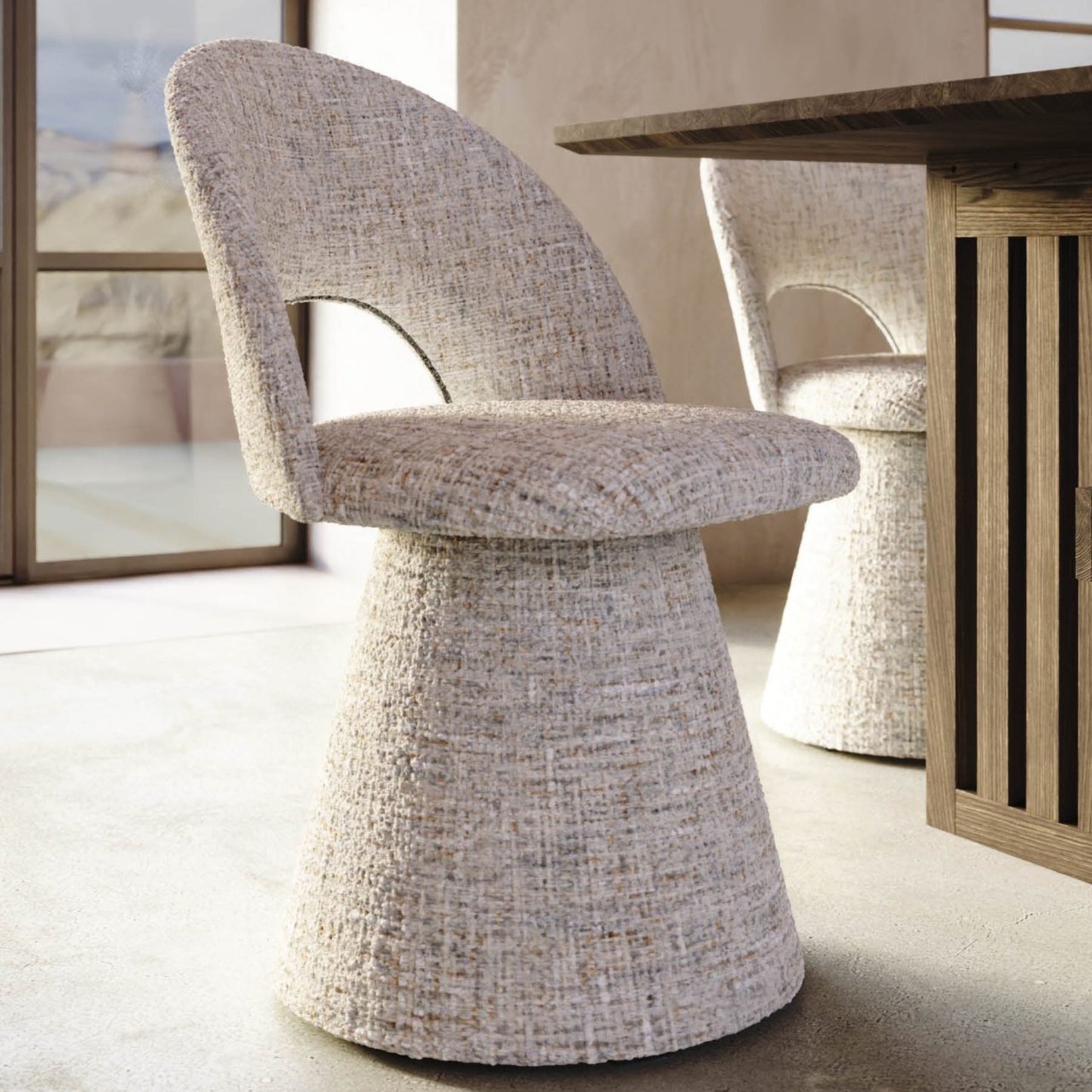 Textured chair in a modern interior setting with a wooden table and abstract art.