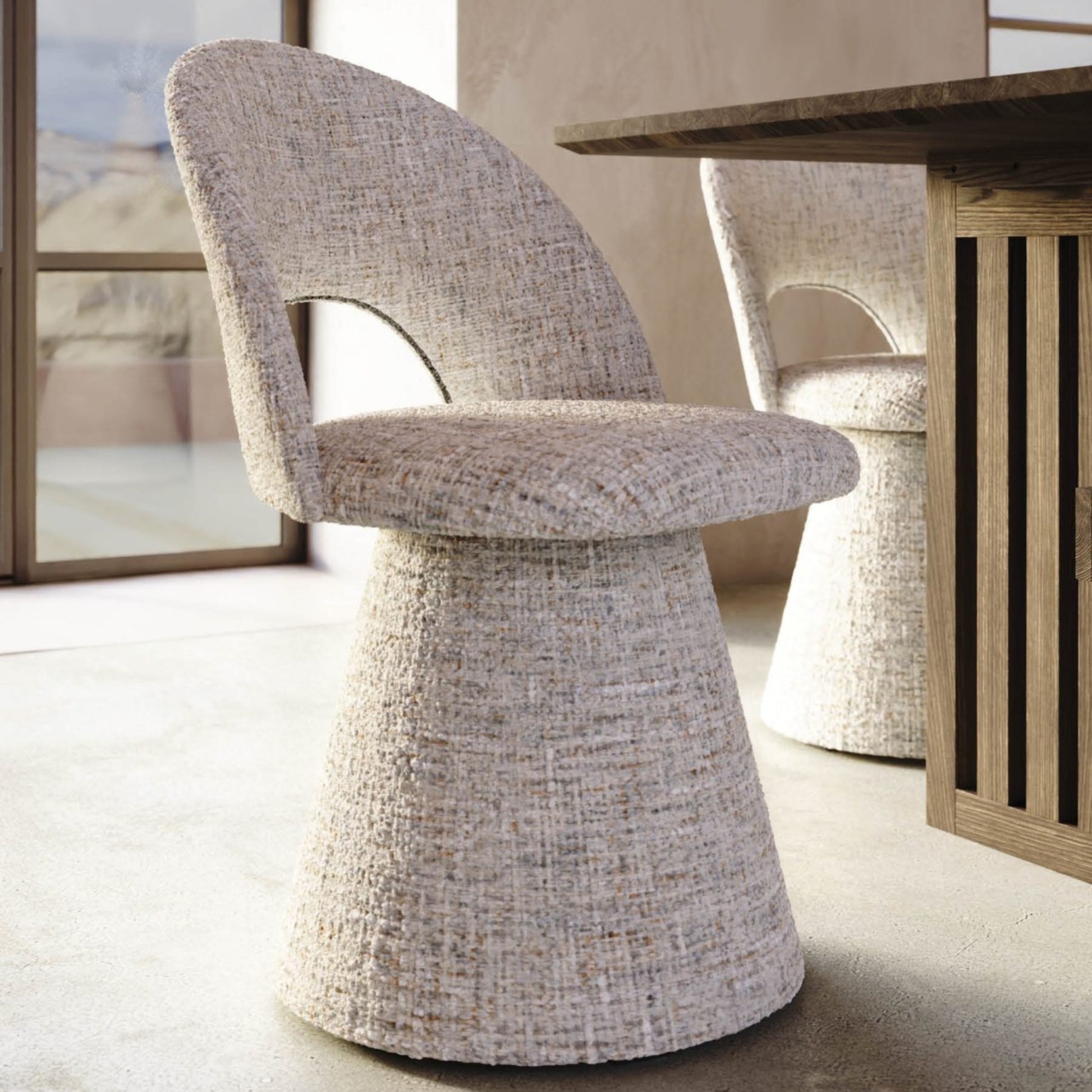 Textured chair in a modern interior setting with a wooden table and abstract art.