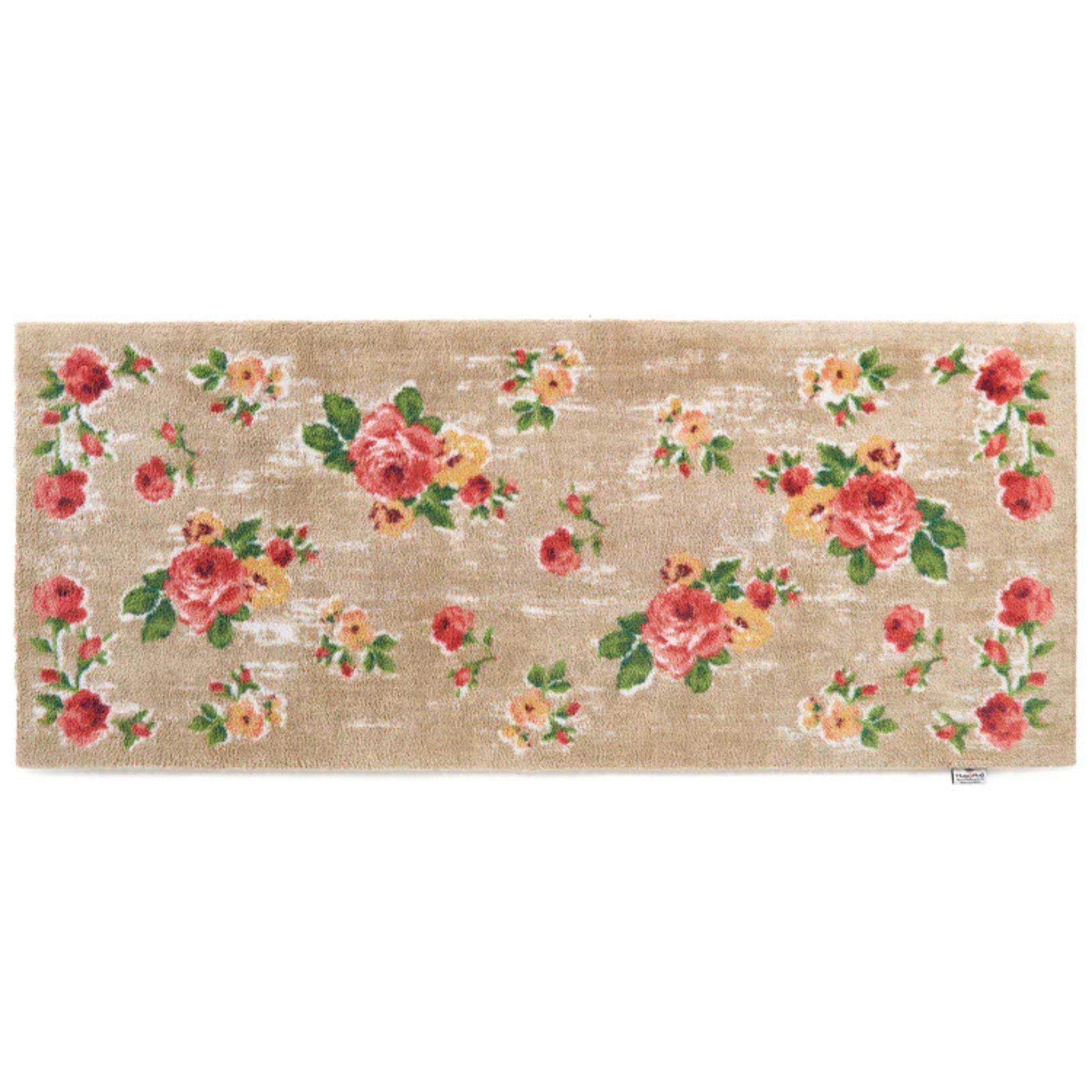 Floral patterned doormat with pink and yellow flowers on a beige background